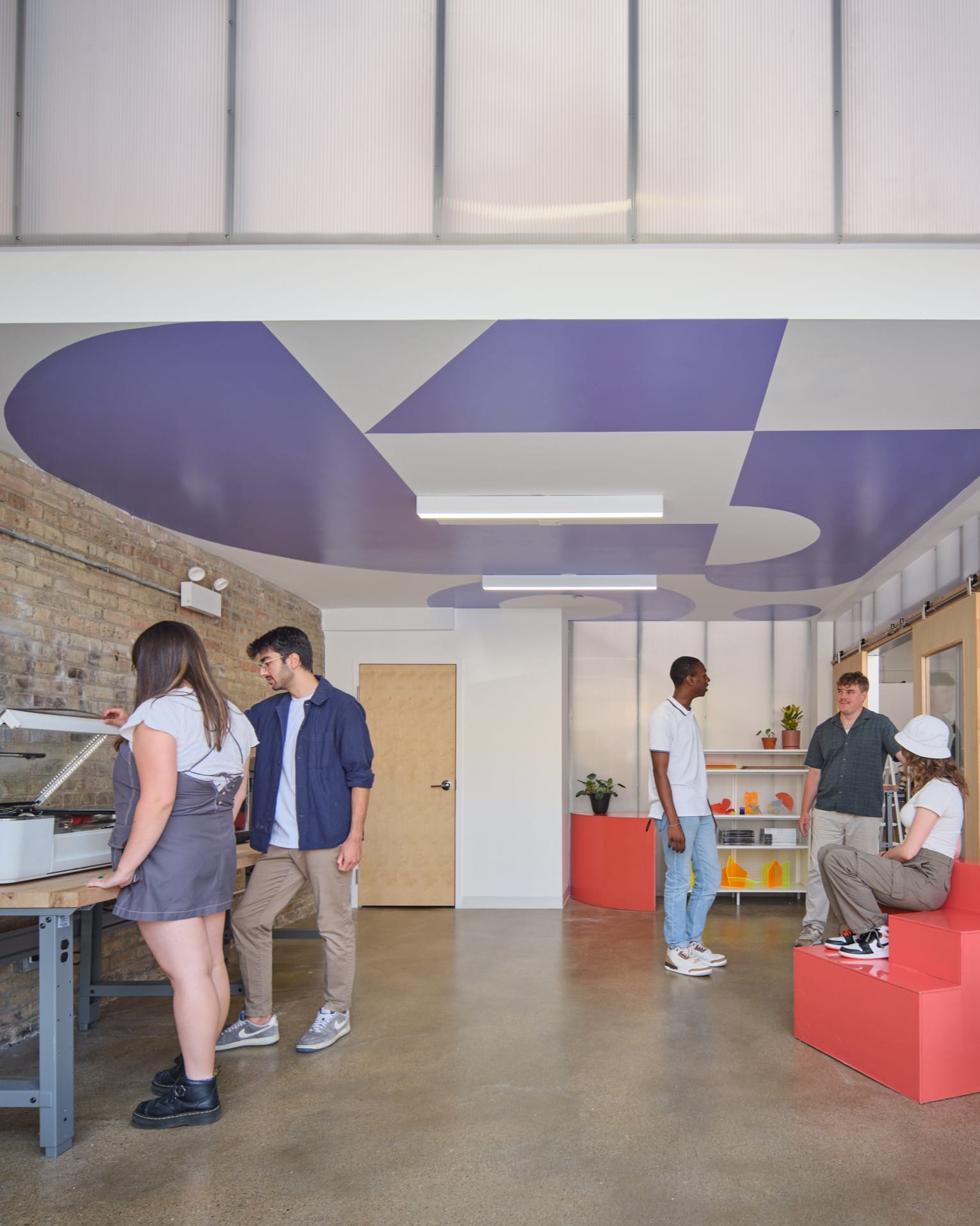 Younge engineers of the future work together in the Mobile Makers studio.