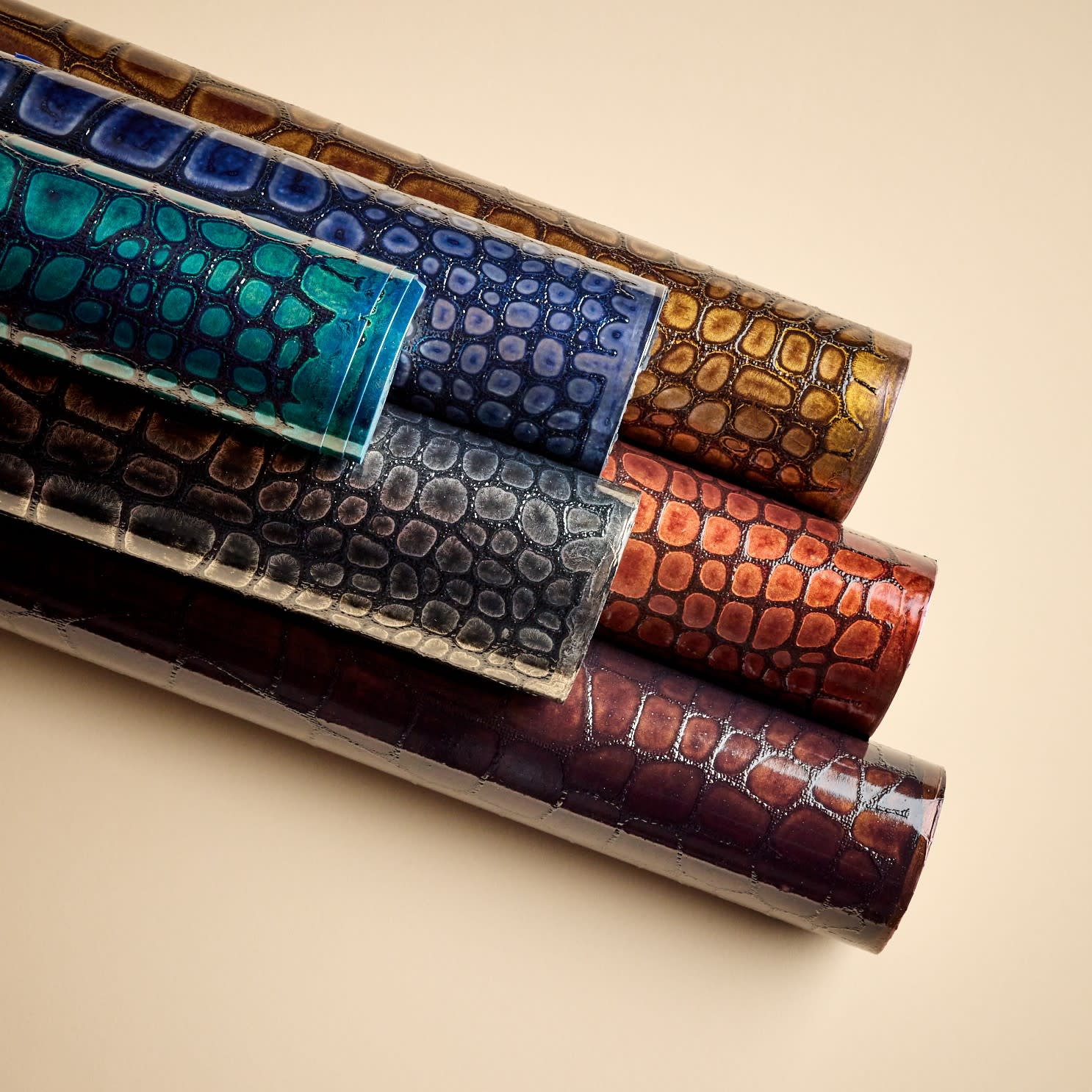 Momentum’s Corso and Corso Lacquer wallcoverings feature a crocodile-like pattern inspired by luxury luggage, crafted with water-based inks and sustainable materials.